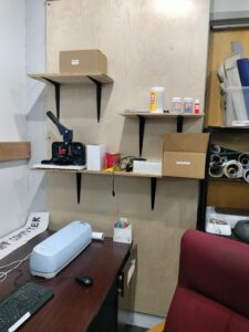 Shelves containing button making materials